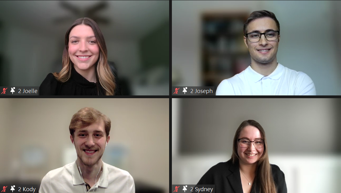 A screenshot of a Zoom meeting with four smiling students.