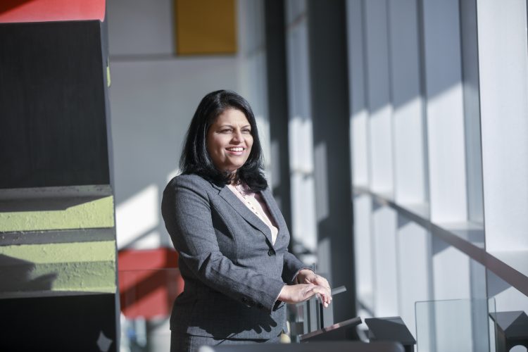 Bibitha Thomas CPA smiling while facing a window.