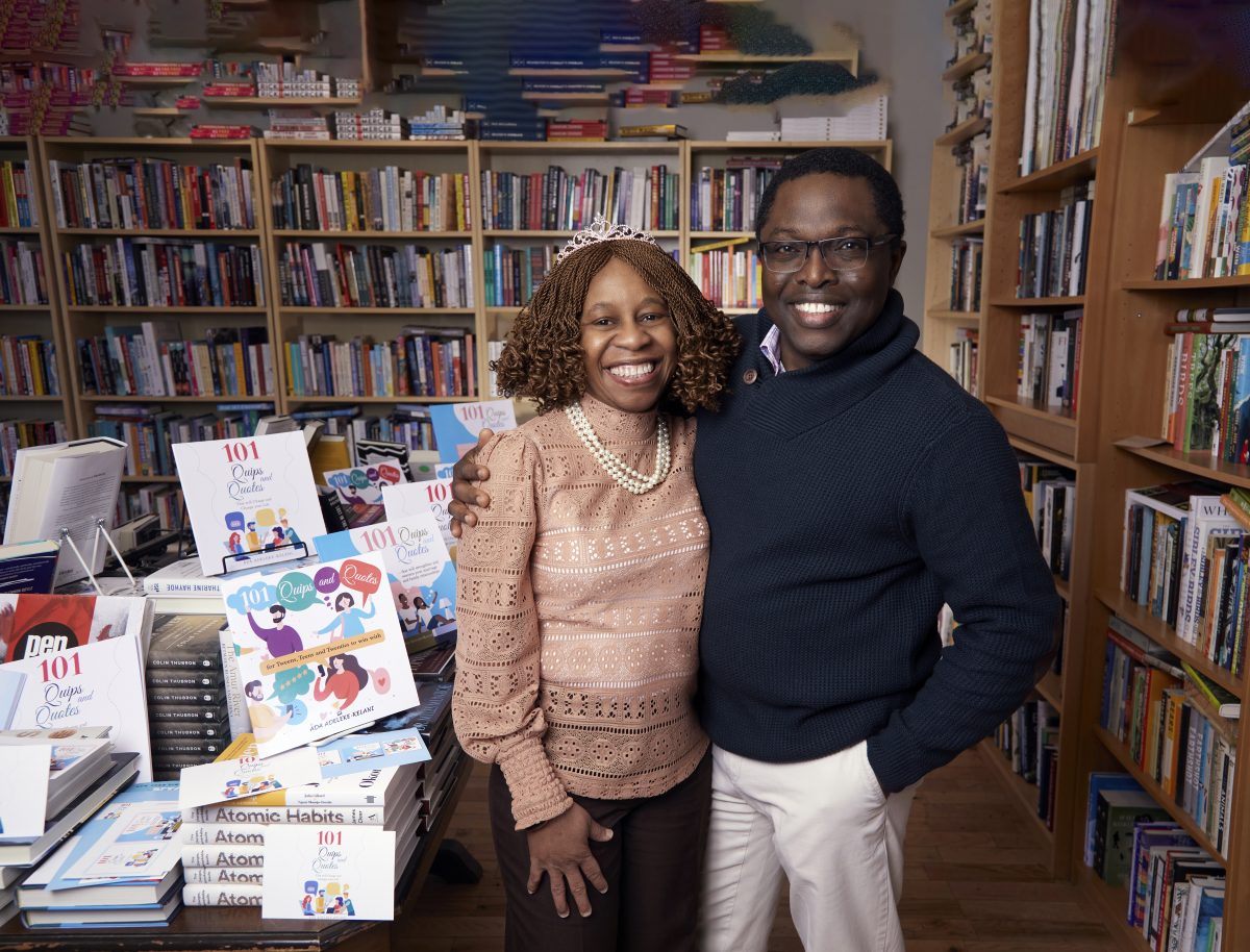 Ada Adeleke-Kelani CPA, CA and her husband are smiling while facing the camera. They are standing next to a collection of books titled '101 Quips and Quotes' and 'Atomic Habits'.