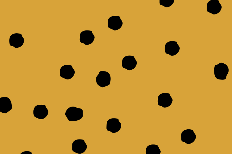 A mustard yellow background with black polka dots.